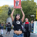 A protester holds a red sign reading “GO FUCK YOURSELF ICE” during the No Kings March in New York City on October 18, 2025, as demonstrators gathered in Union Square to protest injustice and state oppression.