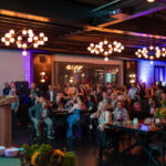 Marc Gordon speaks at a podium while guests listen attentively during the 2025 CHiPS Annual Gala at 501 Union in Park Slope, Brooklyn.