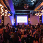 Guests give a standing ovation during the CHiPS 2025 Annual Gala at 501 Union in Park Slope, Brooklyn, as Marc Gordon speaks at the podium.