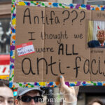 A protester holds a sign that reads “Antifa??? I thought we were ALL anti-facist” with a photo of Donald Trump edited with devil horns, during the No Kings March in New York City.