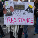 Protester at No Kings March in NYC holds a Star Wars-themed sign that says, “If this were STAR WARS you’d be rooting for the RESISTANCE.”
