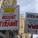 Two handmade protest signs at the No Kings March in NYC read “Squashing Dissent is the 1st Sign of Tyranny” and “Antifascist Like My Father and Uncles in WWII.”