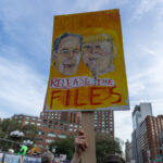 Protester holding a yellow hand-painted sign with portraits of Trump and Epstein reading “Release the Files” during the No Kings March in New York City.