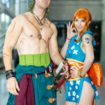 Cosplayers @chrisisonthehunt and @hotgluehime dressed as Zoro and Nami from One Piece, posing together at New York Comic Con 2025 in NYC’s Javits Center.