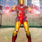 Cosplayer @only.davey dressed as Iron Man from Marvel’s Avengers: Endgame, wearing a red and gold armored suit with both repulsors glowing, posing heroically outdoors at New York Comic Con 2025 in NYC.