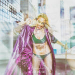 Double exposure portrait of cosplayer @nj_harley_q as The Joker, wearing a purple coat and green outfit with gold chains and smeared makeup, captured at New York Comic Con 2025 in NYC.