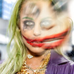 Double exposure portrait of cosplayer @nj_harley_q dressed as The Joker with green hair, red smile makeup, and gold chains, shot at New York Comic Con 2025 in NYC.