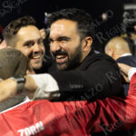 Zohran Mamdani smiles broadly as he hugs supporters on the field following “The Cost of Living Classic” soccer tournament at Maimonides Park in Coney Island.