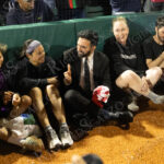 Zohran Mamdani sits on the sidelines in conversation with soccer players during “The Cost of Living Classic” at Maimonides Park in Coney Island.