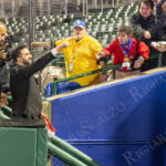 Zohran Mamdani smiles and extends his hand toward cheering supporters in the stands after “The Cost of Living Classic” at Maimonides Park in Coney Island.