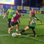 Bronx and Brooklyn players compete for the ball under the lights during “The Cost of Living Classic” soccer tournament at Maimonides Park in Coney Island.