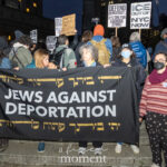 A group of protesters hold a black banner reading “JEWS AGAINST DEPORTATION” in English and Hebrew at the ICE OUT of NYC protest in Foley Square on October 22, 2025.