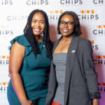 Two women posing and smiling in front of a CHiPS logo backdrop at the 2025 CHiPS Annual Gala in Park Slope, Brooklyn.