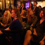 Guests seated and standing attentively during speeches at the CHiPS Annual Gala 2025 at 501 Union in Park Slope, Brooklyn.