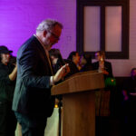 Actor David Costabile speaks at a podium during the CHiPS Annual Gala 2025 at 501 Union in Park Slope, Brooklyn.