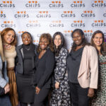 A group of eight people posing and smiling in front of a CHiPS logo backdrop at the 2025 CHiPS Annual Gala in Brooklyn.