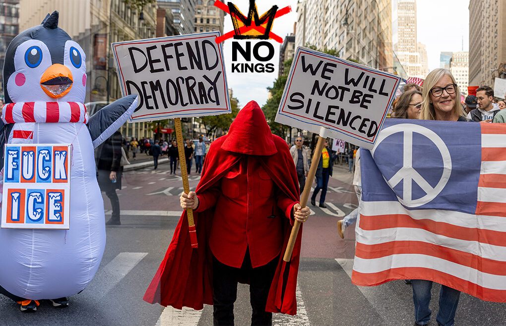 Protesters at the No Kings March in New York City, including one dressed in a penguin costume with an anti-ICE sign, another in a red cloak holding “Defend Democracy” and “We Will Not Be Silenced” signs, and a third holding a peace flag patterned like the U.S. flag, during the October 18, 2025 nationwide protest.