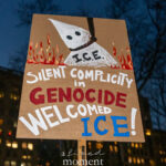 Hand-painted protest sign reading “Silent Complicity in Genocide Welcomed ICE” at a nighttime rally in New York City.
