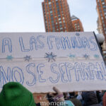Spanish-language protest sign reading “A Las Familias No Se Separan” held above a crowd during a winter protest in New York City.