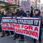 Protesters holding a banner reading “Minnesota Started It — It’s Time for a National Shutdown” during a winter march in New York City.