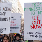 Protest signs reading “For Workers Action to Stop Deportations” and “From Minnesota to NYC ICE Out Now” held during an anti-ICE march in New York City.