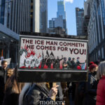 Protester holding a sign that reads “The ICE Man Commeth — He Comes for You!” at the Hands Off protest on January 11, 2026, in New York City.