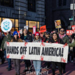 Protesters holding a “Hands Off Latin America!” banner while marching during the Hands Off protest on January 11, 2026, in Midtown Manhattan.