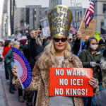 Protester holding “No Wars! No ICE! No Kings!” sign during Hands Off protest in New York City.
