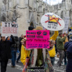 Protester holding a pink sign reading “Renee Nicole Good was murdered! Abolish ICE now!” in New York City.