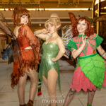 Three fairy cosplayers wearing botanical-themed costumes with iridescent wings, leaf skirts, and elven ears posing together at Dragon Con 2025 in Atlanta, GA by @gijoeinstilettos, @the_eco_cosplayer, and @cici.whitney.