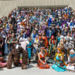 Large fantasy cosplay group photo at Dragon Con 2025 in Atlanta, GA featuring armored warriors, druids, mages, creature costumes, colorful gowns, and detailed handcrafted props posed on outdoor steps.