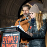Hamish Linklater and Lily Rabe read from prepared remarks at a podium during The People’s Filibuster outside The Public Theater in New York City.