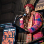 Nia Alsop speaks into a microphone at a podium during The People’s Filibuster outside The Public Theater in New York City.