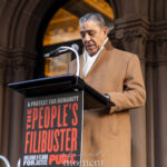 U.S. Representative Adriano Espaillat speaks from a podium during The People’s Filibuster outside The Public Theater in New York City.