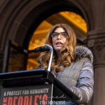 New York City Council Speaker Julie Menin speaks at a podium during The People’s Filibuster outside The Public Theater in Manhattan.