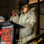Shoshana Bean speaks passionately into a microphone at The People’s Filibuster outside The Public Theater in New York City.