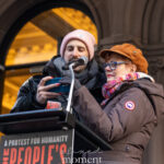 Susan Sarandon stands at a podium reading from a phone during The People’s Filibuster outside The Public Theater in New York City.