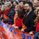 Governor Kathy Hochul, Brad Hoylman-Sigal, and Mayor Zohran Mamdani stand at the front of the Lunar New Year Parade in Chinatown holding a red banner.