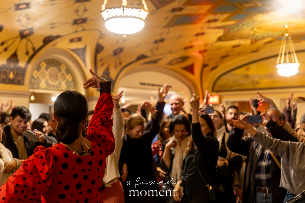 Participants raise their arms while following flamenco movements led by instructor Xianix Barrera during a public dance lesson in the lobby of New York City Center during the Flamenco Festival on March 6, 2026.