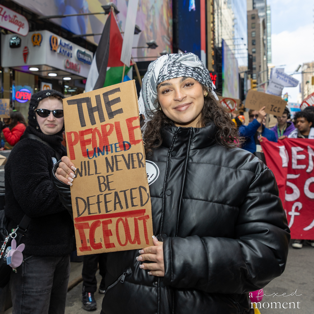 A protester holds a sign reading The People United Will Never Be Defeated during the No Kings protest in New York City.