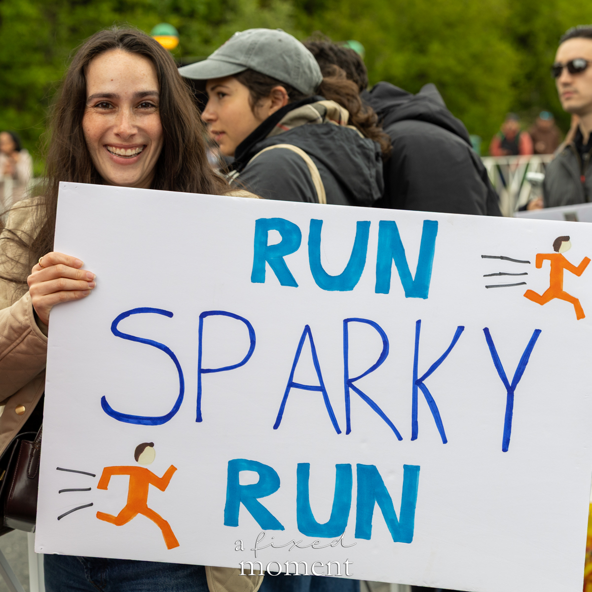 Spectator holds a Run Sparky Run sign