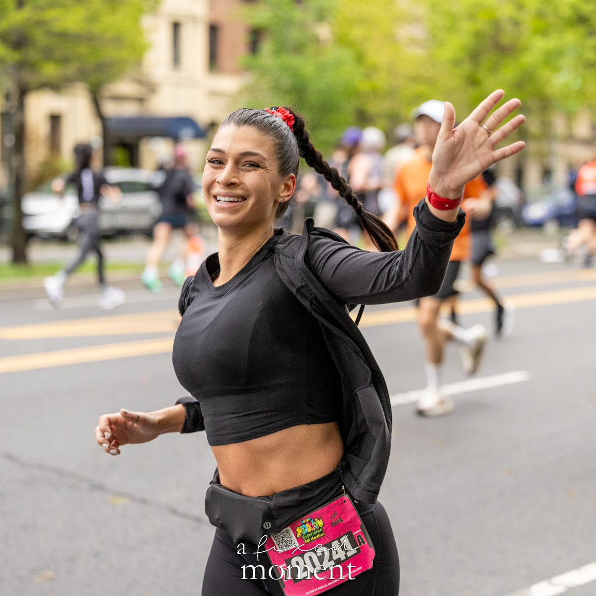 Runner waves during the Brooklyn Experience Half Marathon in Brooklyn on April 26, 2026