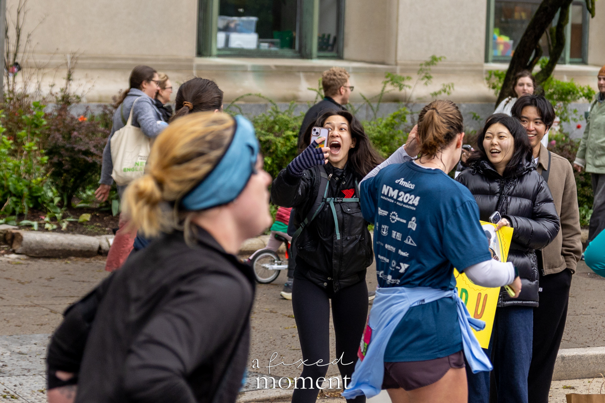 Spectator cheers and records a runner