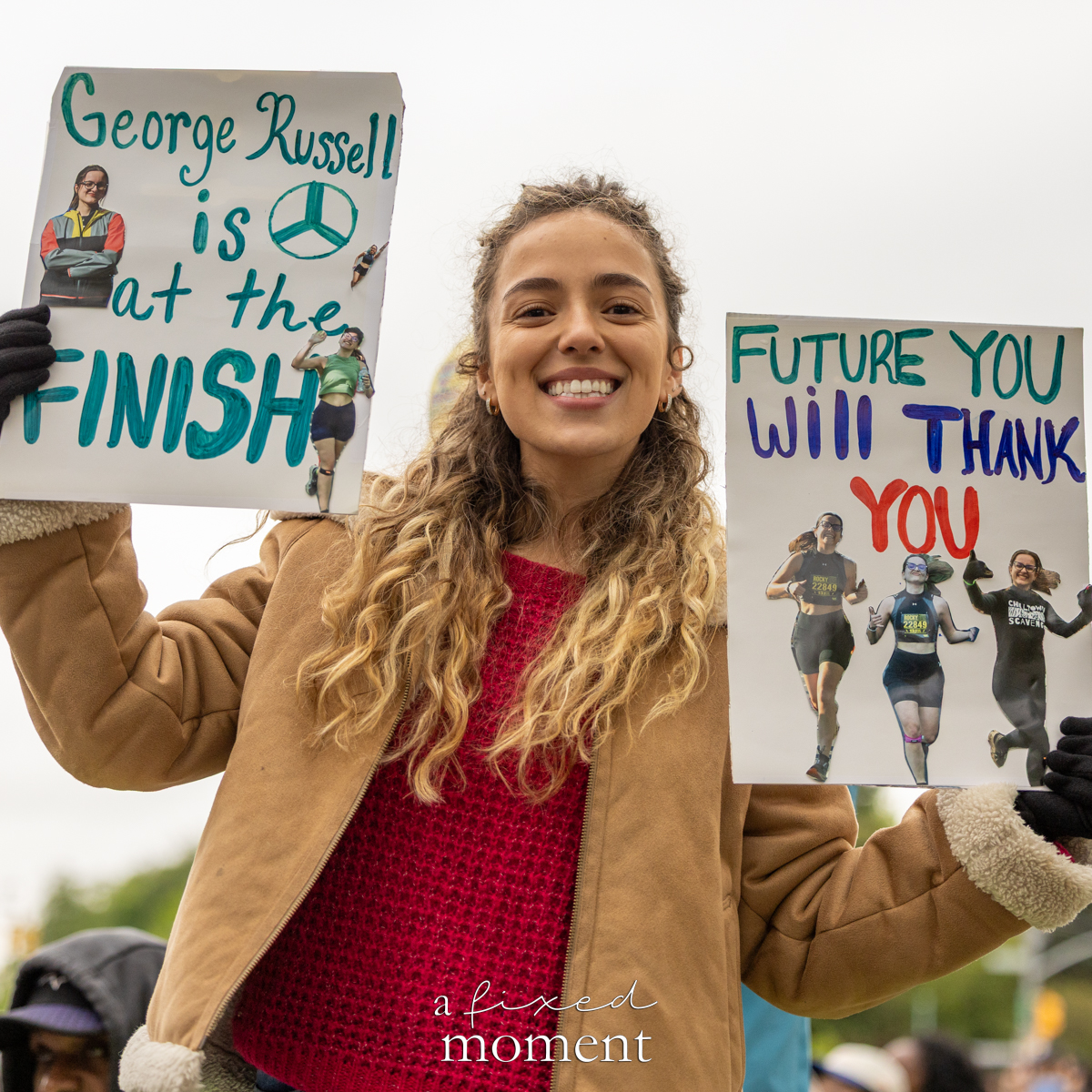 Spectator holds finish line signs during the Brooklyn Experience Half Marathon