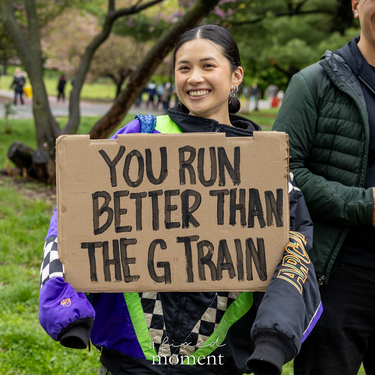 Spectator holds a sign that says You run better than the G train during the Brooklyn Experience Half Marathon