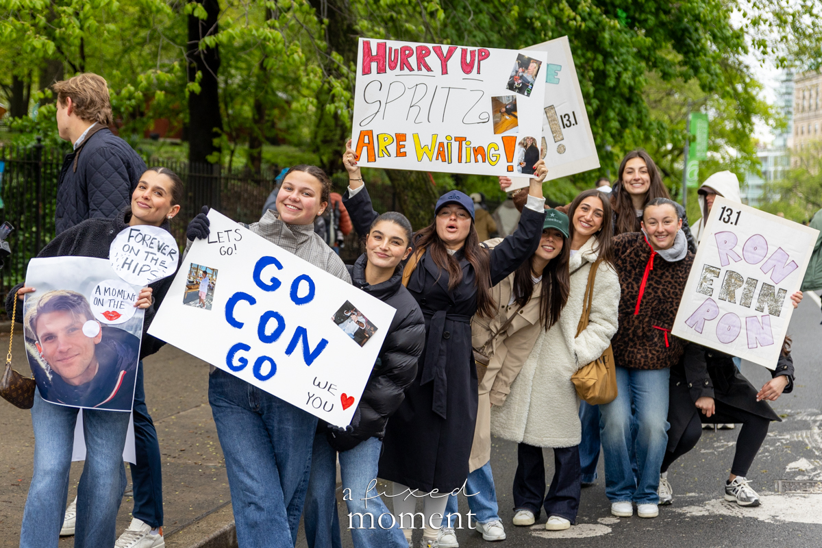 Spectators cheer with handmade signs during the Brooklyn Experience Half Marathon