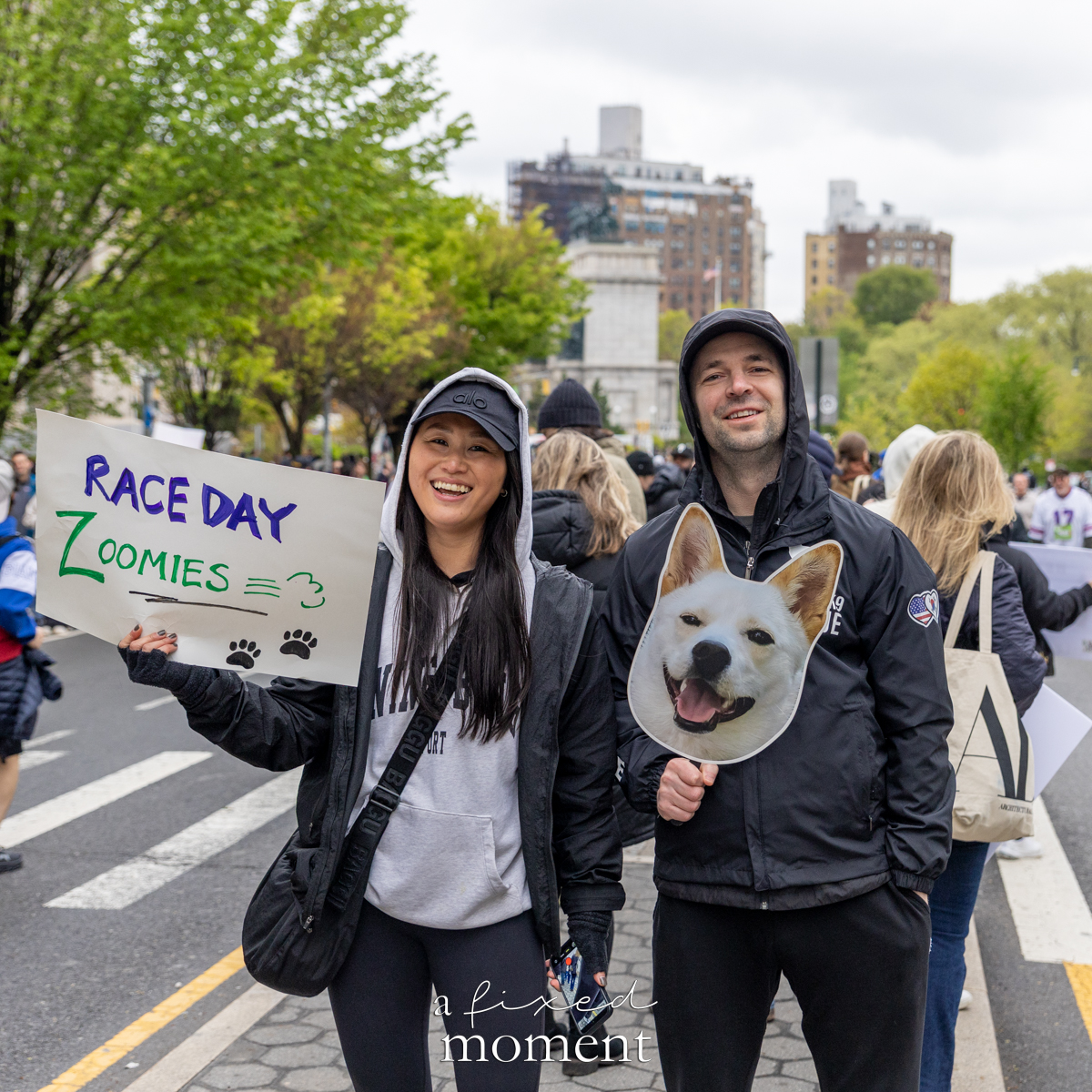 Spectators cheer with race day zoomies sign