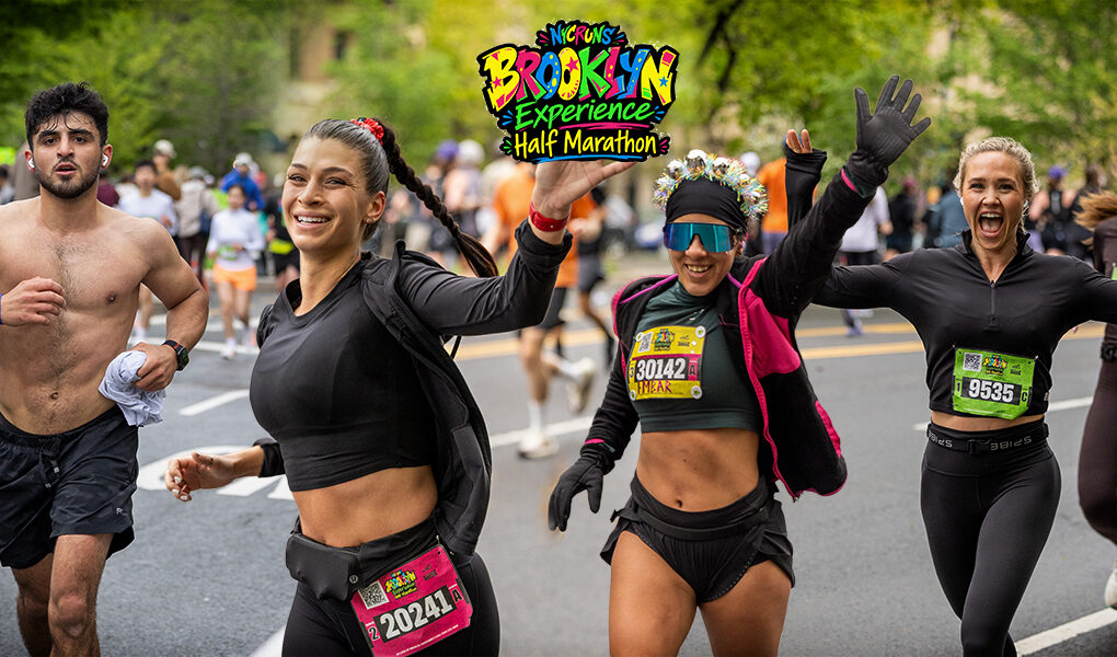 Runners smile, wave, and move through the Brooklyn Experience Half Marathon in Brooklyn, NYC, on April 26, 2026.