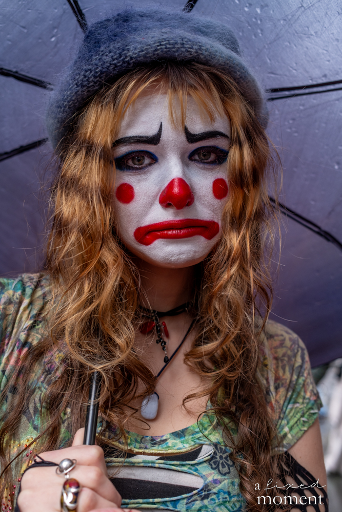 Close portrait of a participant in clown makeup at the Easter Parade and Bonnet Festival.
