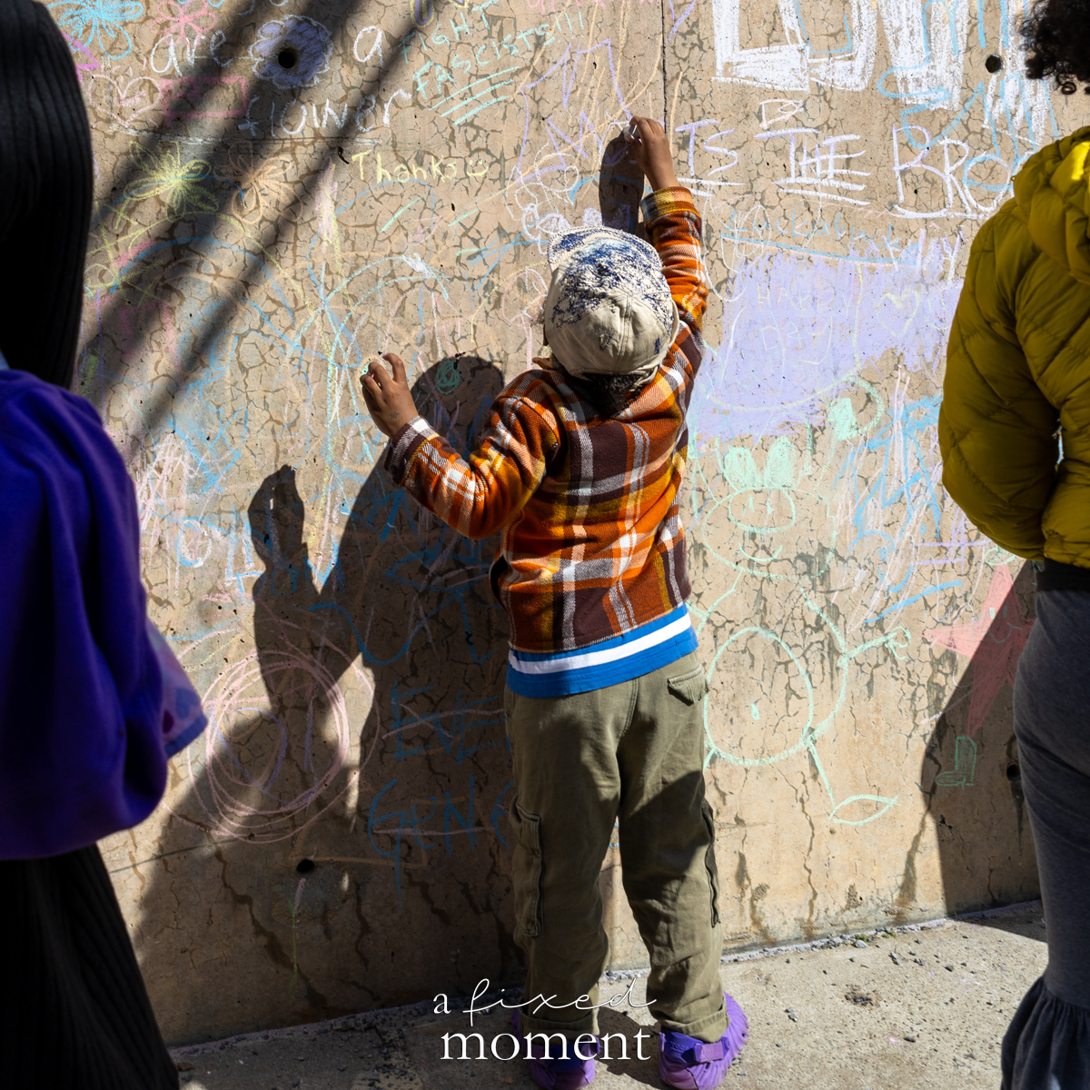 Child drawing on the chalk wall